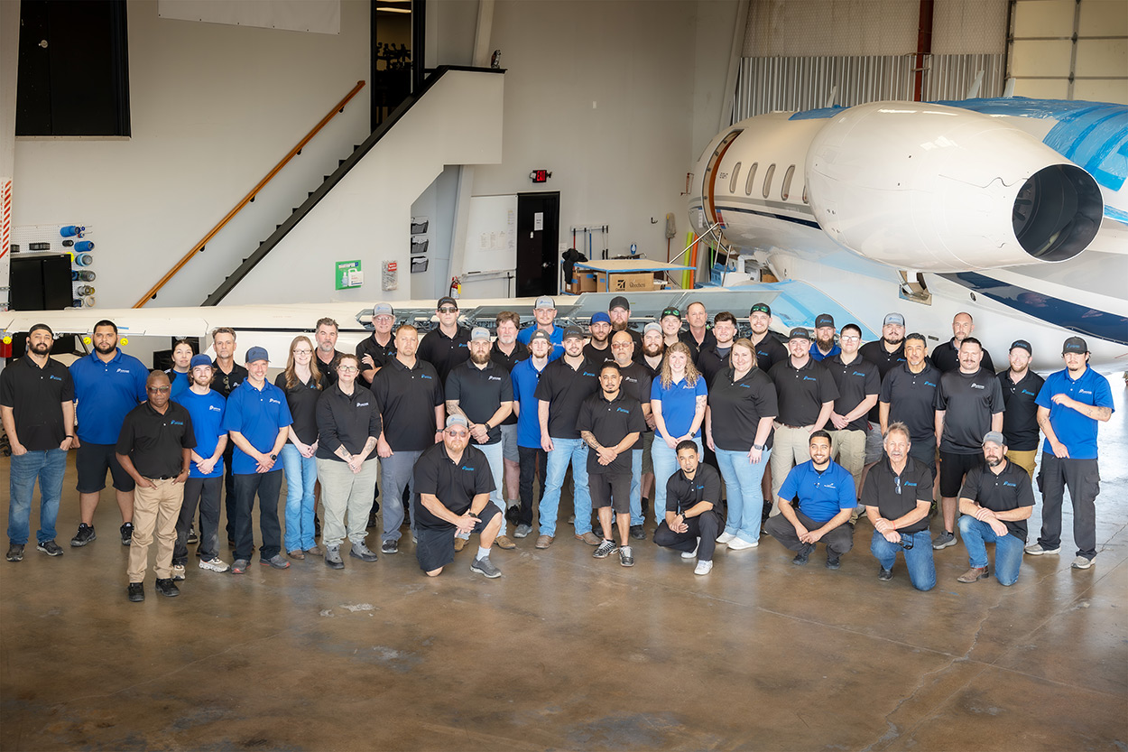 Plane Place Aviation team in front of an aircraft