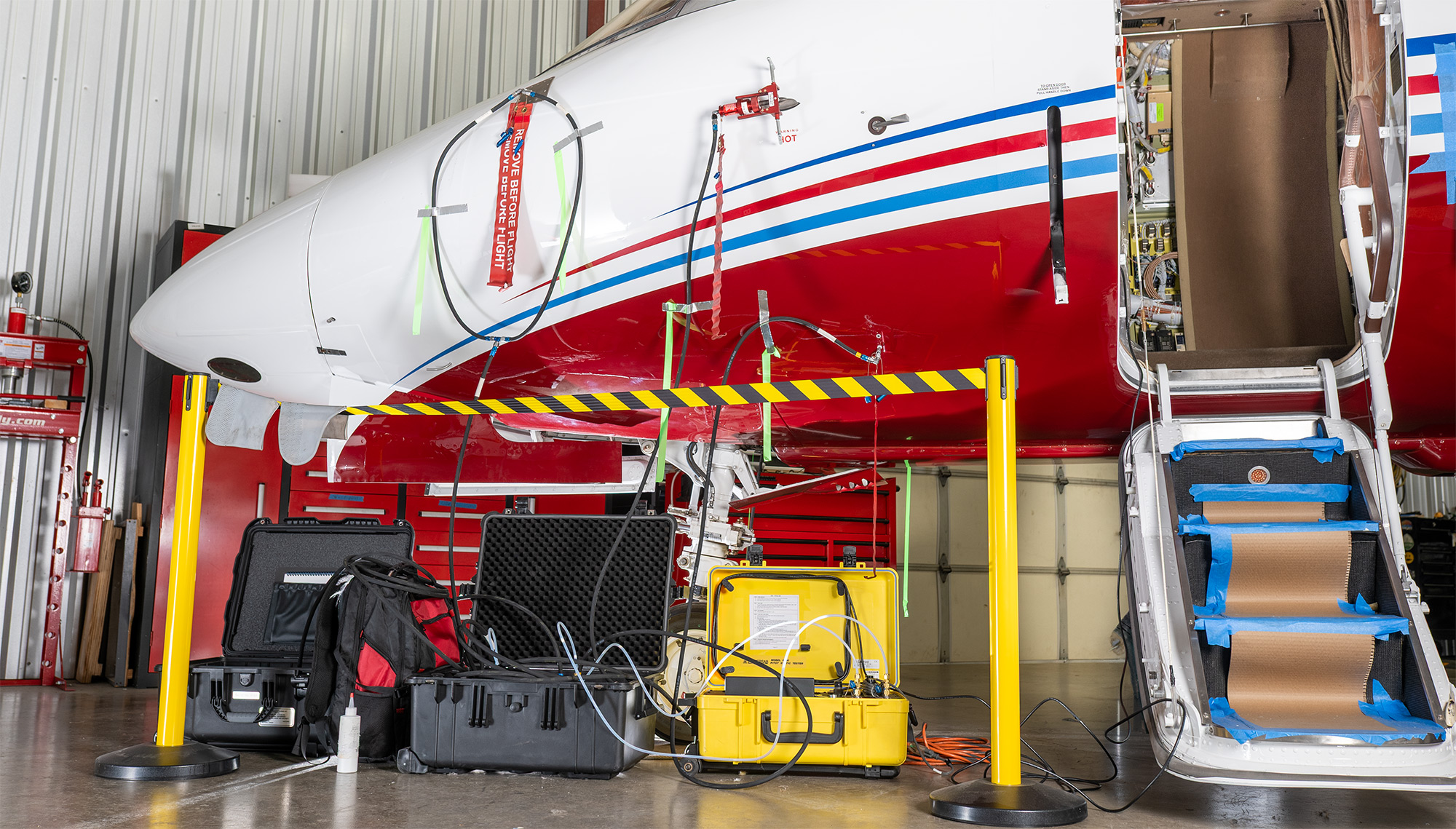 Plane Place Aviation technician performing avionics on business jet